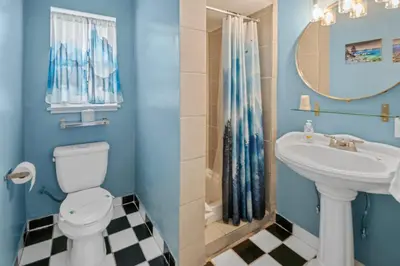 a blue bathroom with a sink and a toilet at Bluebird Day Inn & Suites in South Lake Tahoe