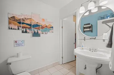 a bathroom with a sink and a toilet and a mirror at Bluebird Day Inn & Suites in South Lake Tahoe