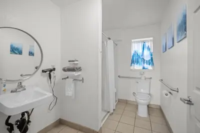 a white bathroom with a sink and a toilet at Bluebird Day Inn & Suites in South Lake Tahoe