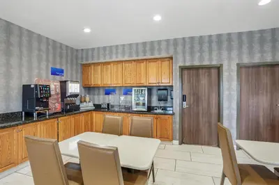a kitchen with a table and chairs in a room at Best Western Porterville Inn in Porterville