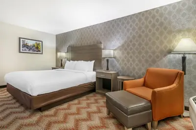 a hotel room with a bed and a chair at Best Western Plus Sonora Oaks Hotel and Conference Center in Sonora