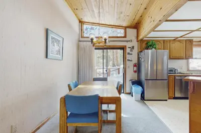 a kitchen with a wooden table and a refrigerator at Tuna Bush in Truckee