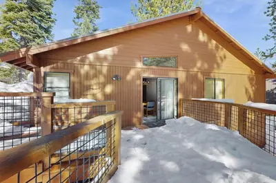 a small wooden house with snow on the porch at Tuna Bush in Truckee