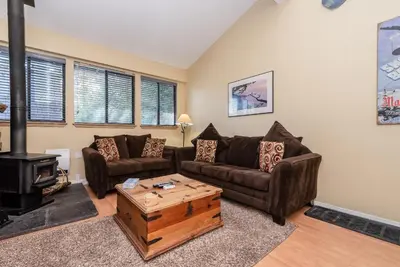 a living room with a couch and a wood stove at Summit B- # 257 in Mammoth Lakes