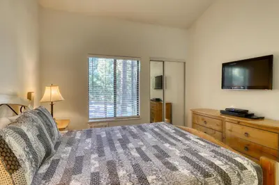 a bedroom with a bed and a flat screen tv at The Summit 276 in Mammoth Lakes