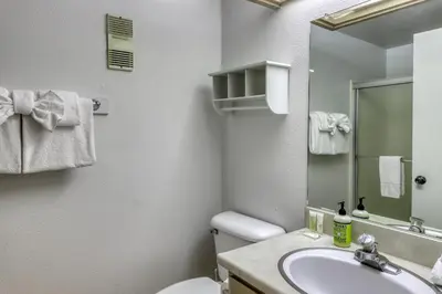 a bathroom with a sink and a toilet and a mirror at The Summit 276 in Mammoth Lakes