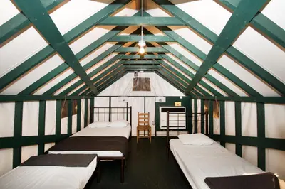 a room with a bunch of beds in a building at Curry Village in Curry Village