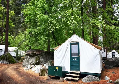 a small tent with a door in a forest at Curry Village in Curry Village