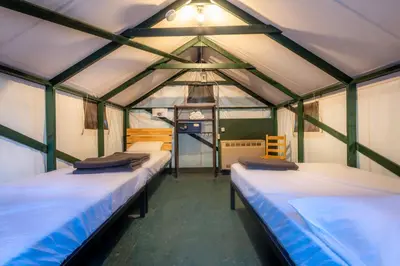 a room with three beds in a greenhouse at Curry Village in Curry Village