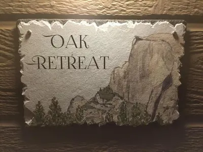 a sign with the name oak retreat on it at Oak Retreat by Yosemite National Park in Coarsegold