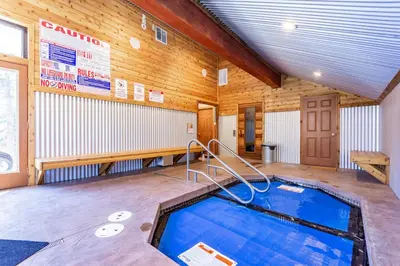 a swimming pool in a room with a wooden wall at San Sierra 2 in Mammoth Lakes