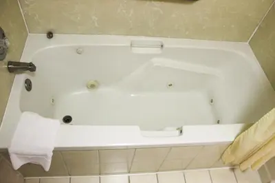 a white bath tub in a bathroom at Hawthorne's Best Inn in Hawthorne