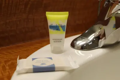 a bottle of toothpaste sitting on top of a sink at Hawthorne's Best Inn in Hawthorne