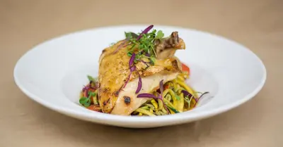 a white bowl of food with chicken and pasta at Yosemite Valley Lodge in Yosemite Village