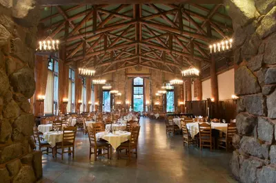 a dining room with tables and chairs in a building at The Ahwahnee in Yosemite Village