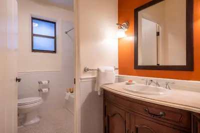 a bathroom with a sink and a toilet and a mirror at The Ahwahnee in Yosemite Village