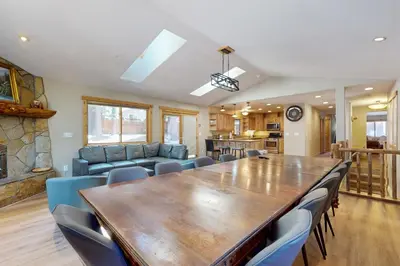 a dining room with a large wooden table and chairs at Sweet Cherry Hills Escape in South Lake Tahoe