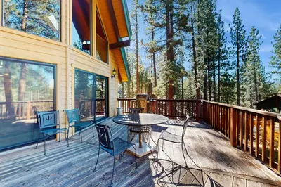 a patio with a table and chairs on a deck at Tallac Views Getaway in South Lake Tahoe