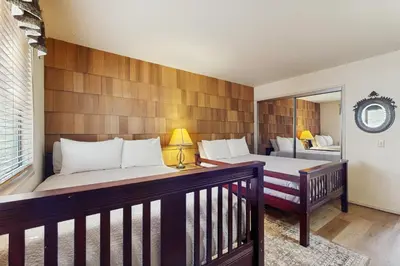 a bedroom with two beds and a balcony at Tallac Views Getaway in South Lake Tahoe