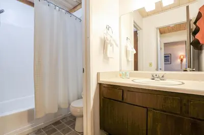 a bathroom with a sink and a toilet and a mirror at Bigwood #80 condo in Mammoth Lakes
