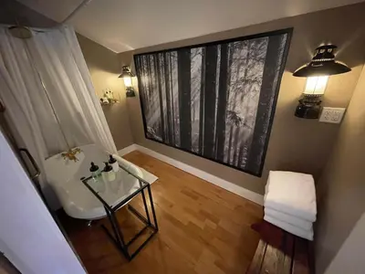 a living room with a glass table and a window at Yosemite Basecamp in Groveland