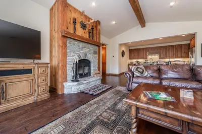 a living room with a couch and a fireplace at Creekhouse 1312 in Mammoth Lakes