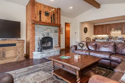 a living room with a couch and a fireplace at Creekhouse 1312 in Mammoth Lakes