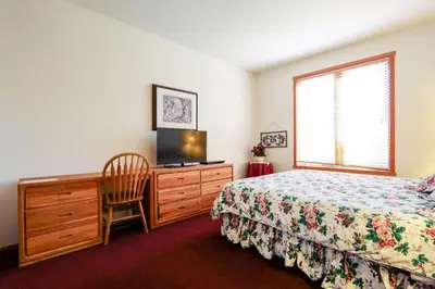 a bedroom with a bed and a dresser with a television at Snowcreek V #999 condo in Mammoth Lakes