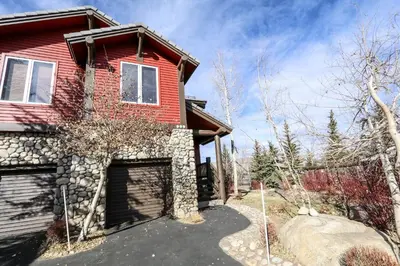 a red house with a garage in front of it at Snowcreek V #999 condo in Mammoth Lakes