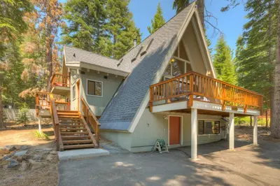 a house with a gambrel roof with two decks at Relaxation on Muletail in Carnelian Bay