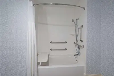 a bathroom with a shower and a white tub at Hampton Inn & Suites Gilroy, Ca in Gilroy