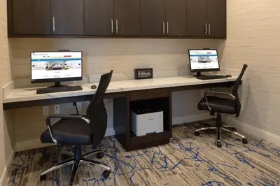 an office with two computer monitors on a desk at Hampton Inn & Suites Gilroy, Ca in Gilroy