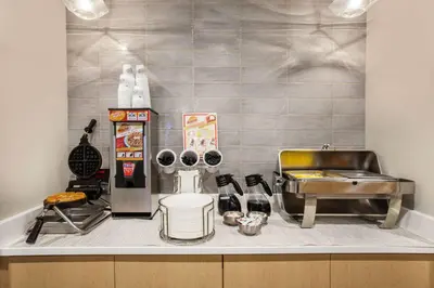 a kitchen with a counter top with a refrigerator and aperature at La Quinta by Wyndham Madera in Madera