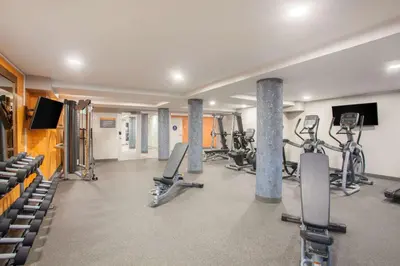 a gym with several treadmills and exercise bikes at La Quinta by Wyndham Madera in Madera