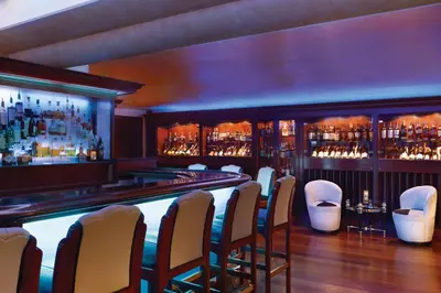 a bar with a row of chairs in a room at Harrah's Lake Tahoe, A Caesars Destination in Stateline