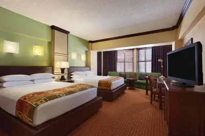a hotel room with two beds and a flat screen tv at Harrah's Lake Tahoe, A Caesars Destination in Stateline