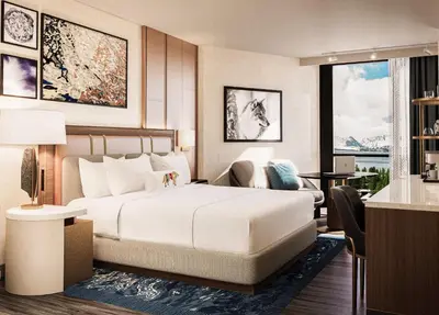a bedroom with a large white bed and a living room at Caesars Republic Lake Tahoe, A Caesars Destination in Stateline