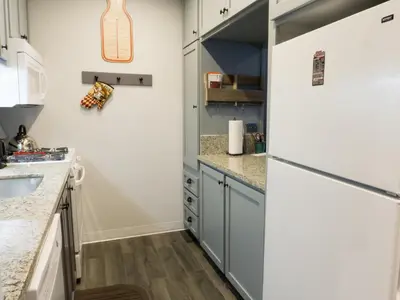 a kitchen with blue cabinets and a refrigerator at Studio Apartment in Truckee