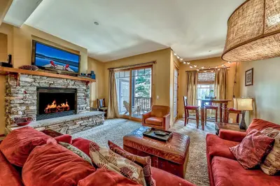 a living room with a couch and a fireplace at Three-Bedroom Townhouse in Kirkwood