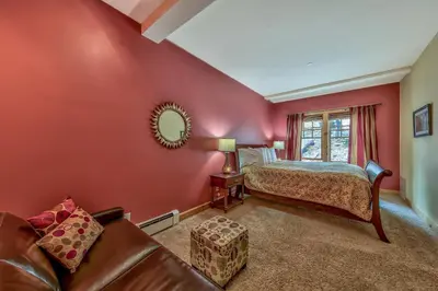 a red bedroom with a bed and a couch at Three-Bedroom Townhouse in Kirkwood