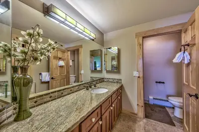 a bathroom with a sink and a vase with flowers at Three-Bedroom Townhouse in Kirkwood