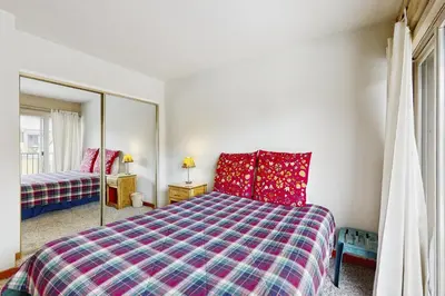 a bedroom with a bed and a mirror at Scott Peak Views in Alpine Meadows