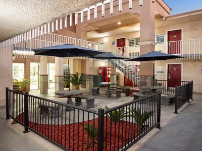 a patio with tables and umbrellas in a building at Dream Inn in Fresno