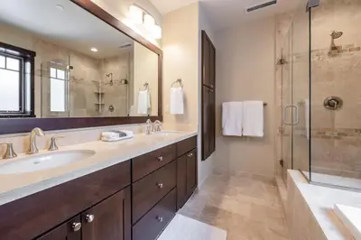 a bathroom with a double sink and a shower at Mountainside 15 in Mammoth Lakes