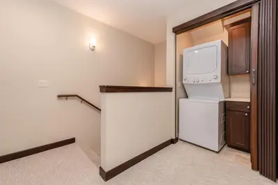 a small kitchen with a refrigerator and a microwave at Mountainside 15 in Mammoth Lakes
