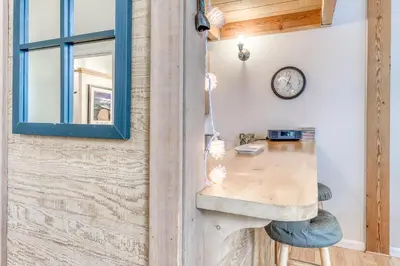 a desk in a room with a clock on a wall at Northstar Condo in the Trees in Truckee
