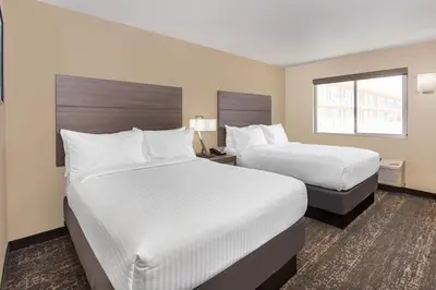 a hotel room with two beds and a window at Days Inn Merced / Yosemite Area in Merced