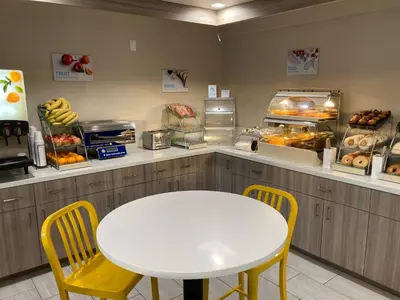 a counter with a white table and chairs in a bakery at Days Inn Merced / Yosemite Area in Merced