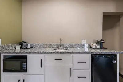 a kitchen with a sink and a microwave at Heritage Inn - Yosemite/Sonora in Sonora