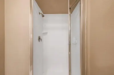 a shower with a glass door in a bathroom at Heritage Inn - Yosemite/Sonora in Sonora